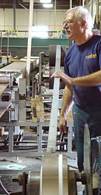 Production manager George Strange checking a rolling mill.